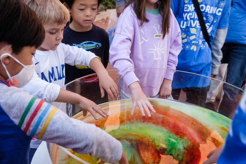Children explore swirly and colorful fluid flows with EPSS SpinLab at EYU 2022.