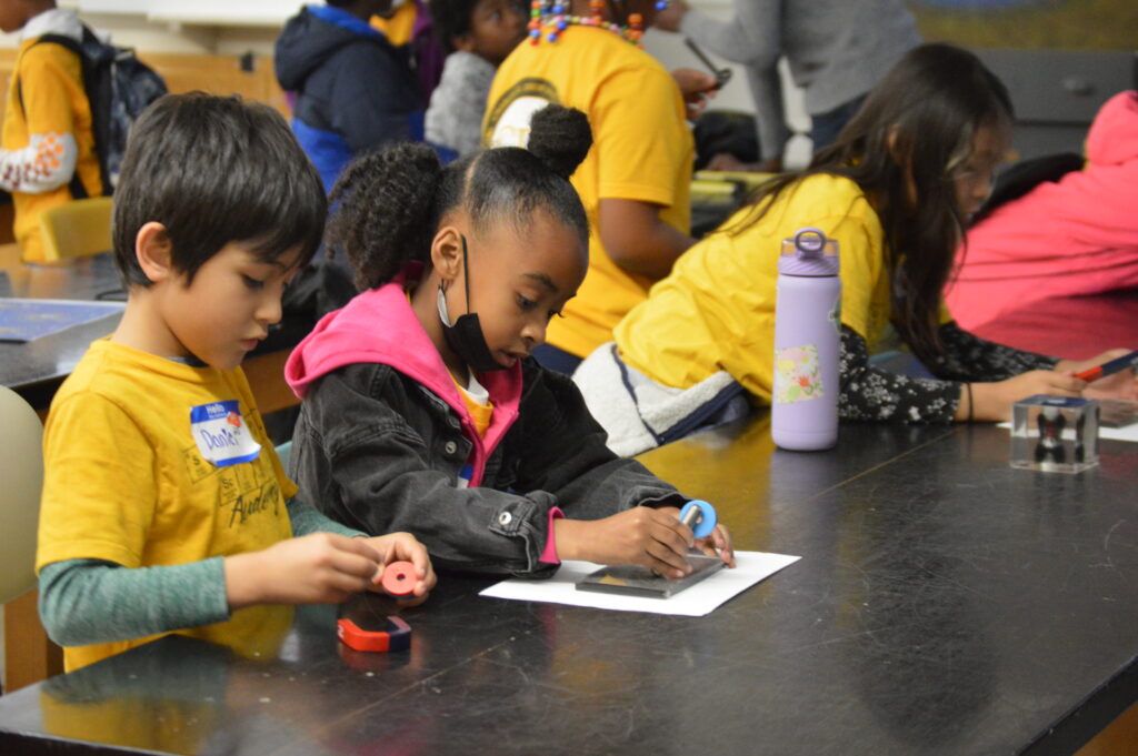 Young students from the Saturday Science Academy run by Charles Drew University in South LA are pictured doing a science activity with UCLA EPSS.